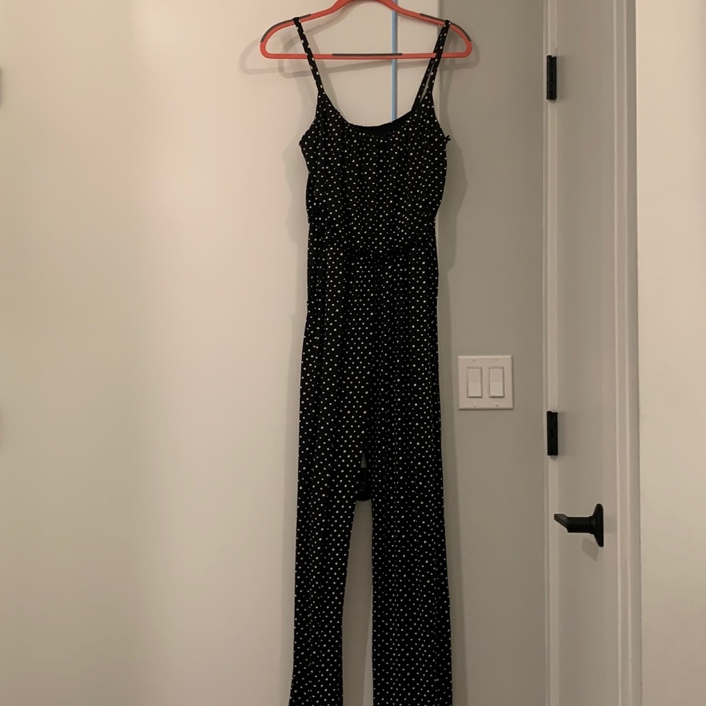 Black with white polka dot jumpsuit with pockets. Silky material and stretchy.